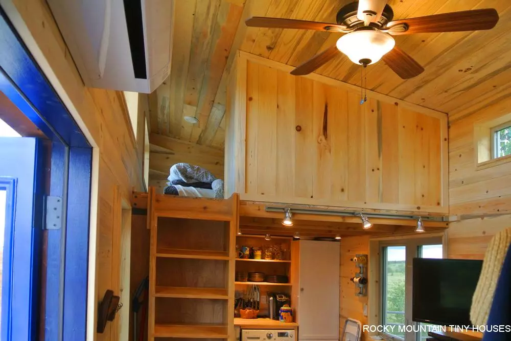 The Rusted Mountain Roost's guest bedroom is accessed by ladder