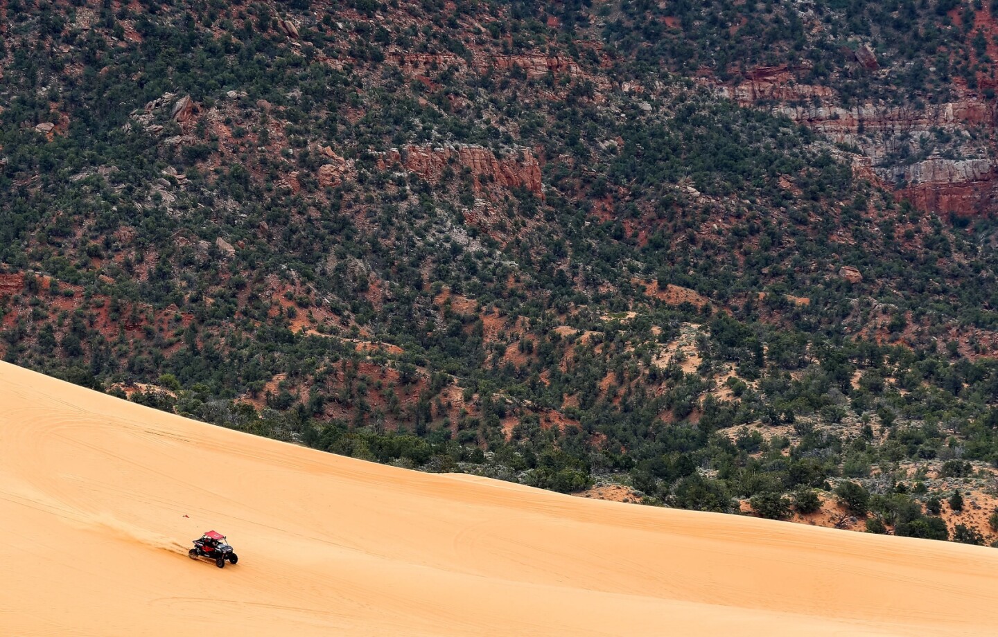 The author sails down a dune headed for certain disaster when he attempts to create epic rooster tails of sand, but superior skill (luck) saves the day