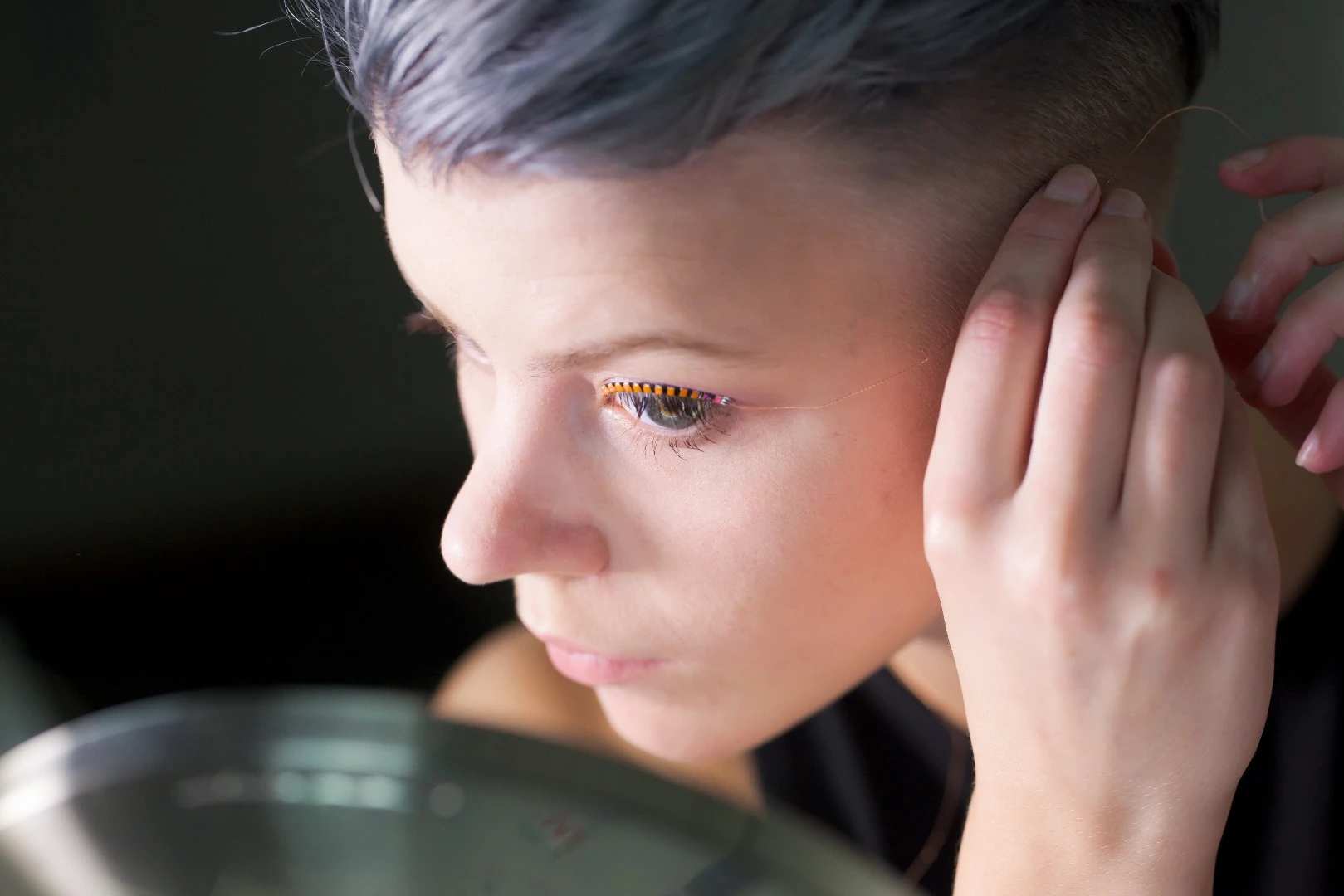 A thin wire connects the f.lashes LED eyelashes to the controller