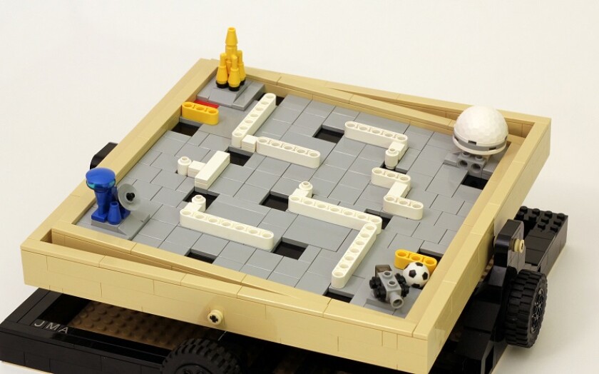 The Labyrinth Marble Maze features a built-in container to store balls, a travel-lock and indents for the balls to drop into