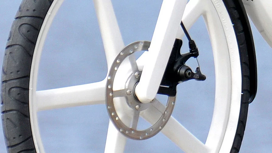 A cable-operated disc brake and injection moulded wheel at the front