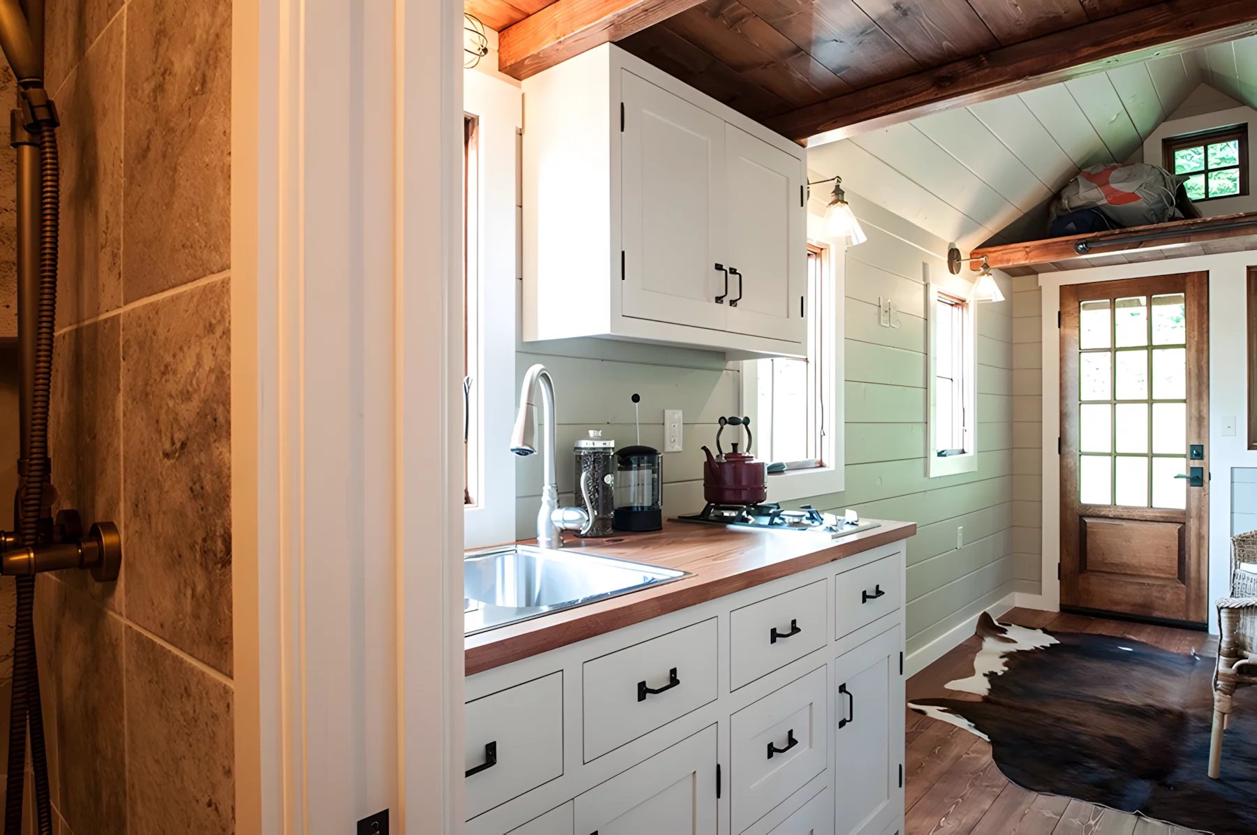 The Ynez's kitchen includes a two-burner propane-powered stove, a fridge/freezer, and a sink