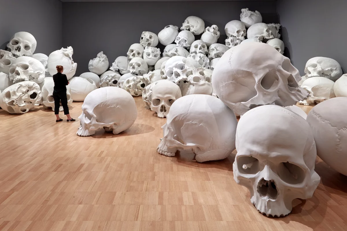 Ron Mueck's huge installation features 100 giant skulls strewn around the gallery's classic art collection